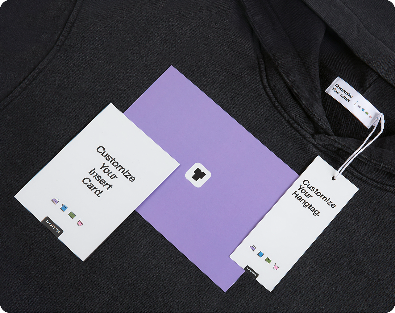 Tapstitch custom branding services featuring branded hangtags, insert cards, and packaging accessories on apparel